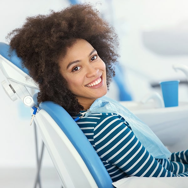 A young woman at the dentist waiting for her botox treatment smiling